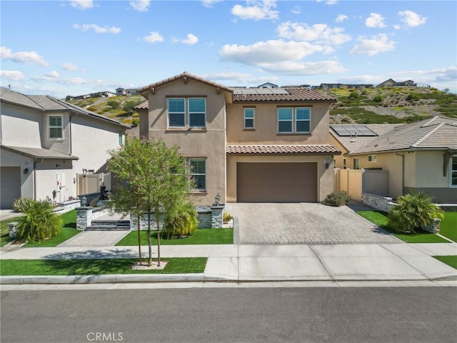 28600 Foothill Way, Saugus, CA 91350 - view of front of home with stucco siding, a tile roof, solar panels, driveway, and an attached garage
