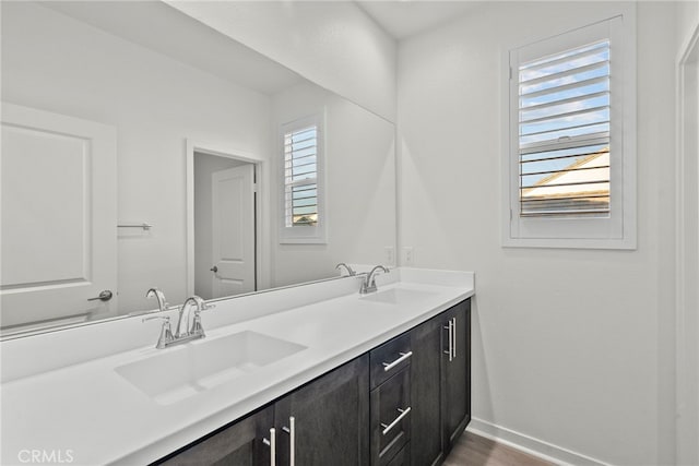 28600 Foothill Way, Saugus, CA 91350 - bathroom featuring baseboards, double vanity, and wood finished floors