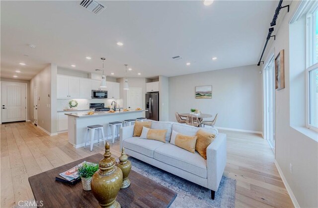 1705 Almond Tree Pl, Upland, CA 91784 - living area with light wood-style floors, recessed lighting, and baseboards