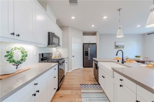 1705 Almond Tree Pl, Upland, CA 91784 - kitchen with appliances with stainless steel finishes, a sink, light wood-style flooring, tasteful backsplash, and white cabinetry