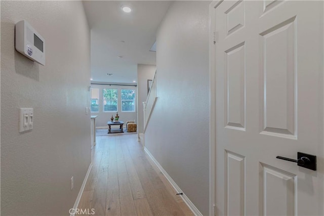 1705 Almond Tree Pl, Upland, CA 91784 - corridor with light wood-type flooring, baseboards, and stairs