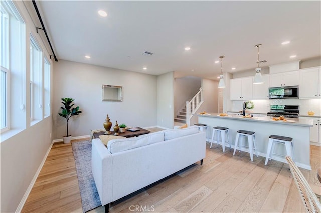 1705 Almond Tree Pl, Upland, CA 91784 - living room with light wood-style flooring, baseboards, recessed lighting, and stairs