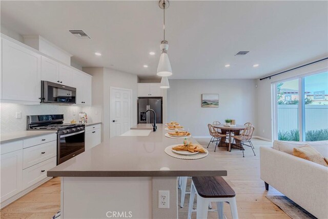 1705 Almond Tree Pl, Upland, CA 91784 - kitchen featuring appliances with stainless steel finishes, tasteful backsplash, recessed lighting, a kitchen bar, and a sink