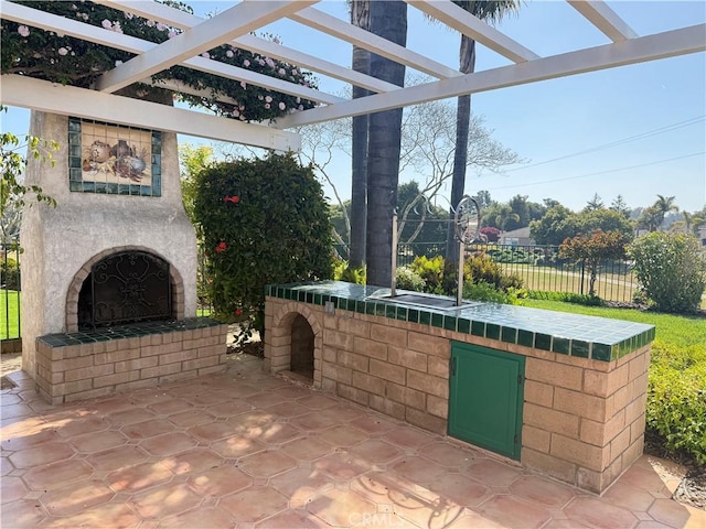 1145 Oakmont Pl, Nipomo, CA 93444 - view of patio featuring exterior fireplace, area for grilling, fence, and a pergola