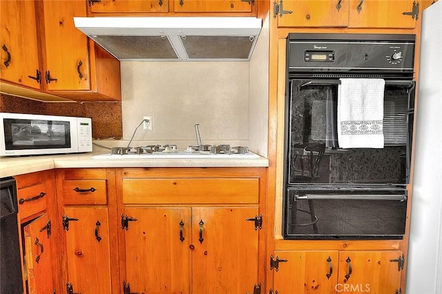 18021 E Cypress St, Covina, CA 91722 - kitchen featuring black appliances, exhaust hood, a warming drawer, and light countertops
