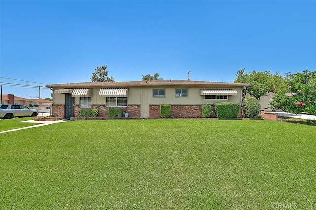 18021 E Cypress St, Covina, CA 91722 - single story home with a front lawn, brick siding, and stucco siding