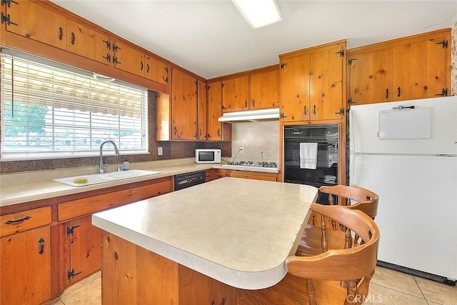 18021 E Cypress St, Covina, CA 91722 - kitchen featuring white appliances, a sink, under cabinet range hood, and light tile patterned flooring