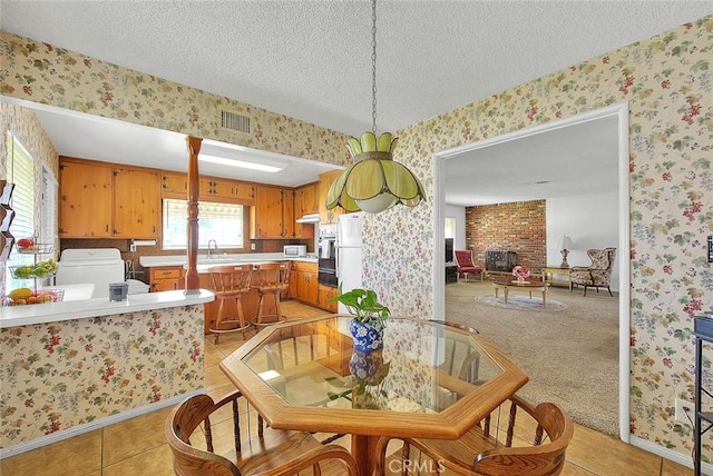 18021 E Cypress St, Covina, CA 91722 - dining space featuring wallpapered walls, a textured ceiling, light tile patterned flooring, and baseboards