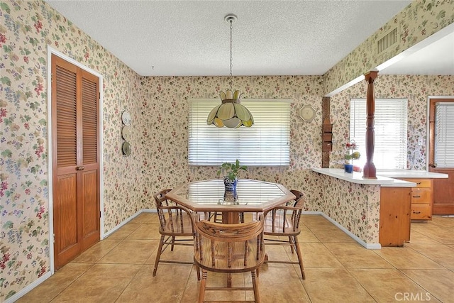 18021 E Cypress St, Covina, CA 91722 - dining room featuring a textured ceiling, wallpapered walls, light tile patterned floors, and baseboards