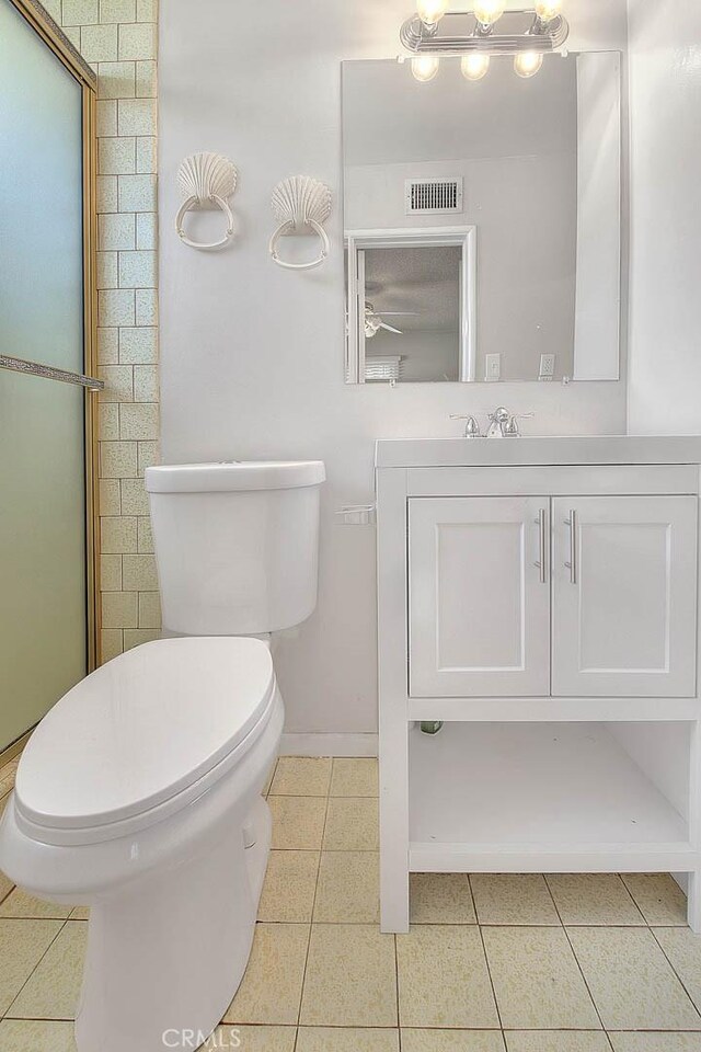 18021 E Cypress St, Covina, CA 91722 - bathroom featuring toilet, vanity, tile patterned flooring, baseboards, and ceiling fan