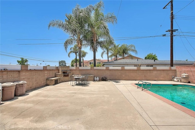 18021 E Cypress St, Covina, CA 91722 - view of swimming pool with a patio area, a fenced backyard, and an outdoor brick fireplace