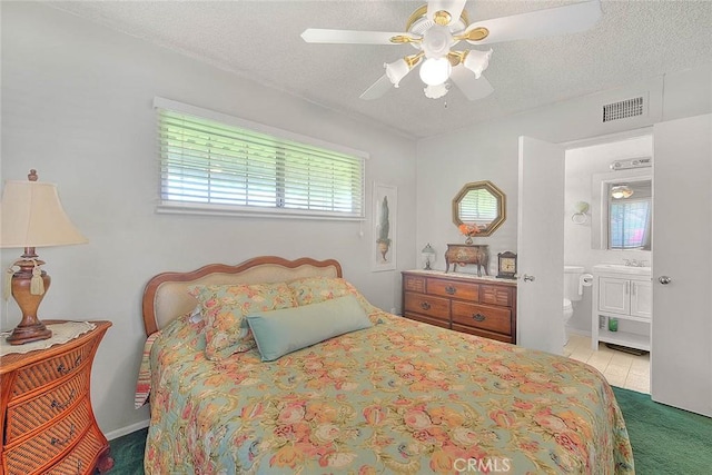 18021 E Cypress St, Covina, CA 91722 - carpeted bedroom featuring a textured ceiling, ensuite bath, and a ceiling fan