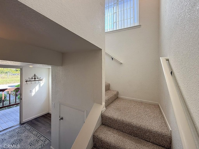 540 Pico Ave Unit 110, San Simeon, CA 93452 - staircase with baseboards, a textured wall, and wood finished floors