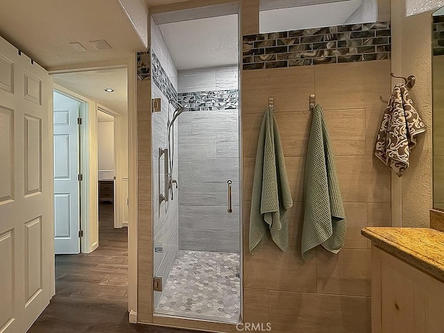 540 Pico Ave Unit 110, San Simeon, CA 93452 - bathroom featuring a shower stall, vanity, and wood finished floors