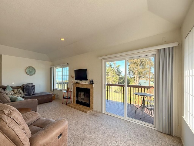 540 Pico Ave Unit 110, San Simeon, CA 93452 - carpeted living room with lofted ceiling, a tile fireplace, and baseboards
