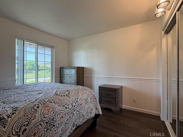 540 Pico Ave Unit 110, San Simeon, CA 93452 - bedroom featuring dark wood-style flooring and wainscoting