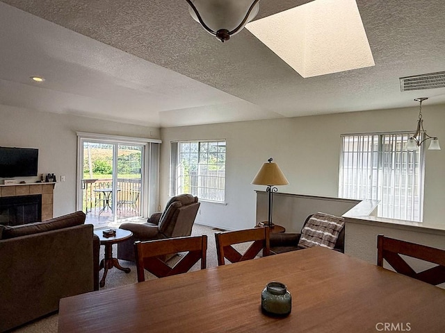 540 Pico Ave Unit 110, San Simeon, CA 93452 - dining space with a textured ceiling, a tile fireplace, carpet flooring, and recessed lighting