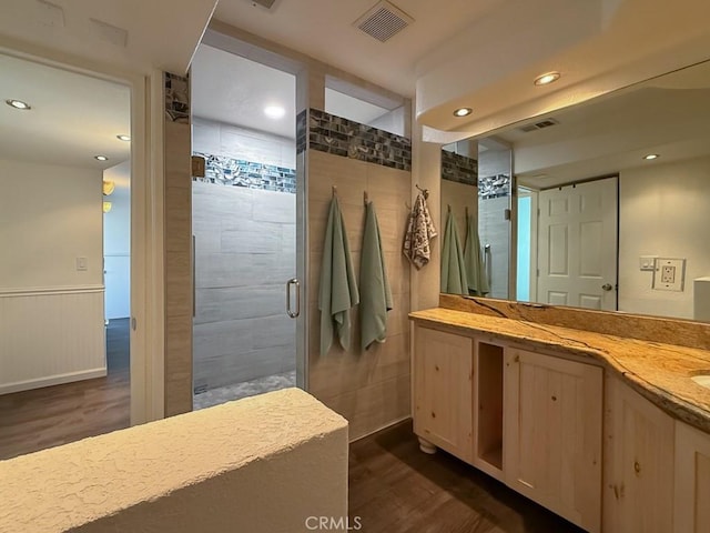 540 Pico Ave Unit 110, San Simeon, CA 93452 - bathroom with wood finished floors, a shower stall, recessed lighting, vanity, and wainscoting