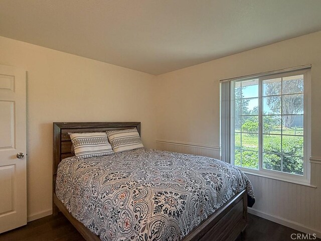 540 Pico Ave Unit 110, San Simeon, CA 93452 - bedroom featuring dark wood-style flooring, multiple windows, and baseboards