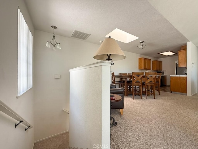 540 Pico Ave Unit 110, San Simeon, CA 93452 - dining room with light carpet, a textured ceiling, and baseboards
