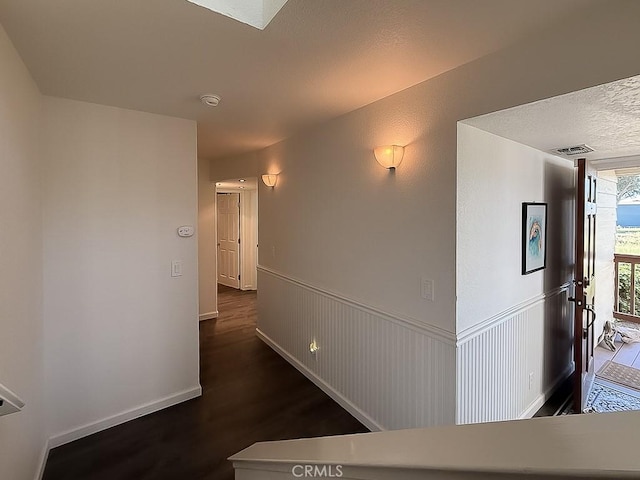 540 Pico Ave Unit 110, San Simeon, CA 93452 - corridor featuring wood finished floors, a textured ceiling, and baseboards