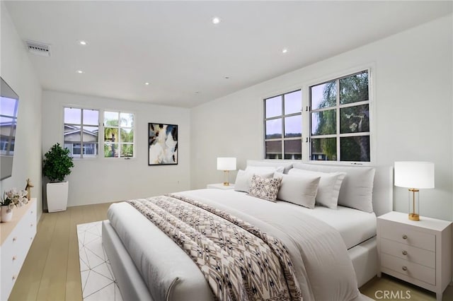 bedroom with recessed lighting and light wood-type flooring