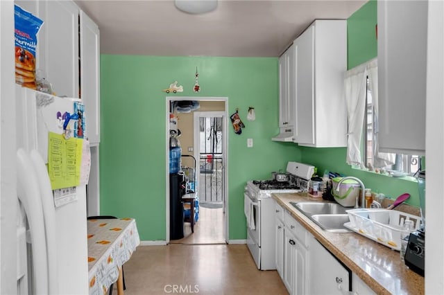 kitchen with white gas range oven, a sink, ventilation hood, and white cabinets