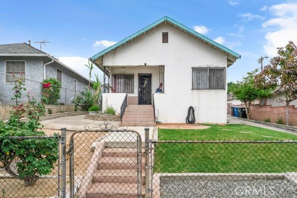 bungalow-style house featuring a gate and stucco siding