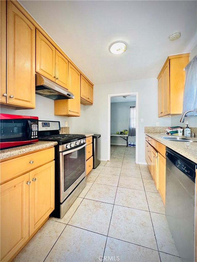 945 N Dickel St, Anaheim, CA 92805 - kitchen with appliances with stainless steel finishes, under cabinet range hood, a sink, light countertops, and light tile patterned floors