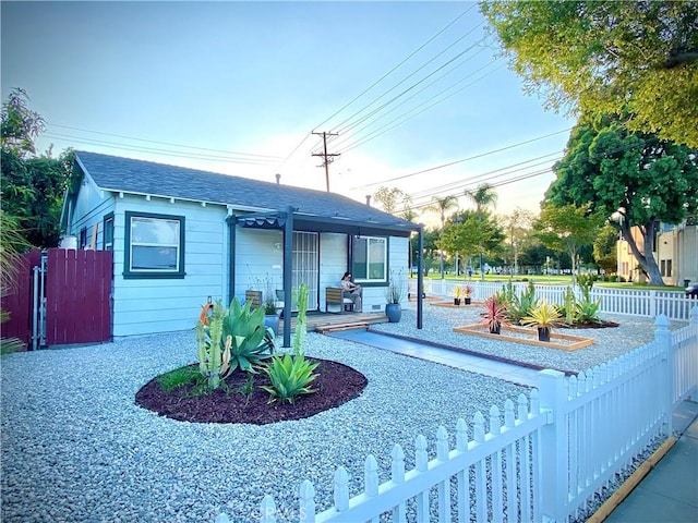 945 N Dickel St, Anaheim, CA 92805 - view of front of home with a porch, fence, and roof with shingles