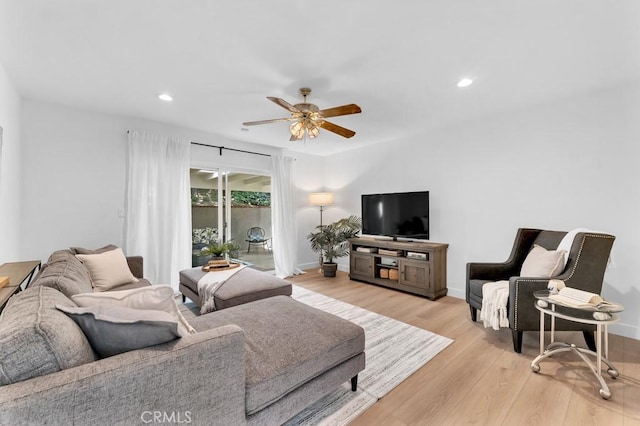living area featuring a ceiling fan, light wood-type flooring, baseboards, and recessed lighting