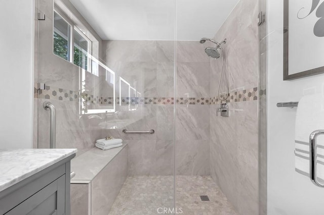 bathroom featuring a shower stall and vanity