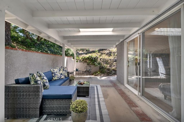 view of patio with outdoor lounge area and fence