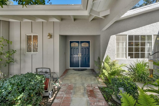 doorway to property featuring board and batten siding