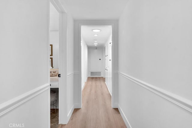hallway with light wood-style floors