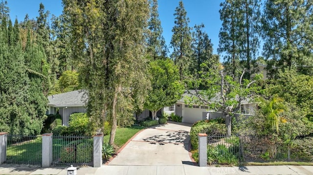 obstructed view of property featuring driveway