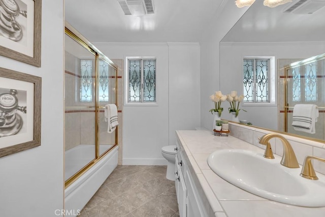 bathroom with vanity, toilet, bath / shower combo with glass door, and crown molding