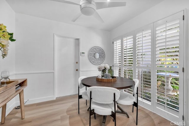 dining space with light wood-type flooring and a ceiling fan