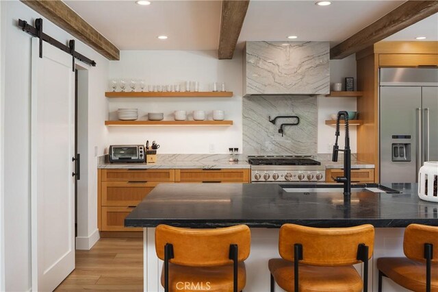 2315 Heather Ln, Newport Beach, CA 92660 - bar with built in refrigerator, beam ceiling, wall chimney exhaust hood, a barn door, and light wood-type flooring