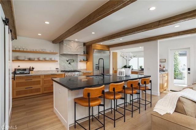 2315 Heather Ln, Newport Beach, CA 92660 - kitchen with open shelves, built in refrigerator, beamed ceiling, light wood-style flooring, and a kitchen bar