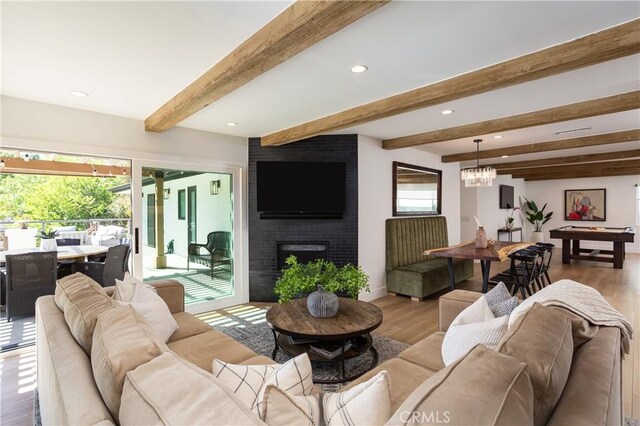 2315 Heather Ln, Newport Beach, CA 92660 - living room featuring wood finished floors, beam ceiling, a brick fireplace, recessed lighting, and a chandelier