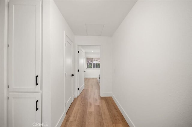 2812 Loyola St, Riverside, CA 92503 - hallway featuring baseboards, light wood-style floors, and attic access