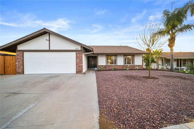 2812 Loyola St, Riverside, CA 92503 - single story home with driveway, a garage, brick siding, fence, and stucco siding
