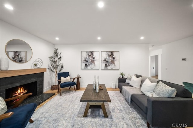 2812 Loyola St, Riverside, CA 92503 - living room featuring recessed lighting, a warm lit fireplace, and wood finished floors
