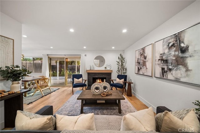 2812 Loyola St, Riverside, CA 92503 - living area with light wood-style floors, a warm lit fireplace, and recessed lighting