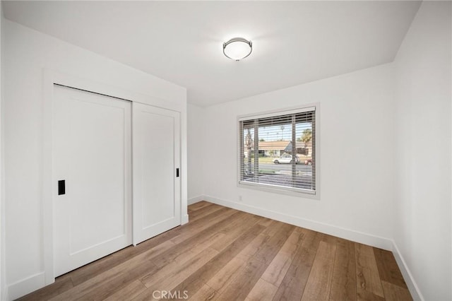 2812 Loyola St, Riverside, CA 92503 - unfurnished bedroom featuring light wood finished floors, baseboards, and a closet