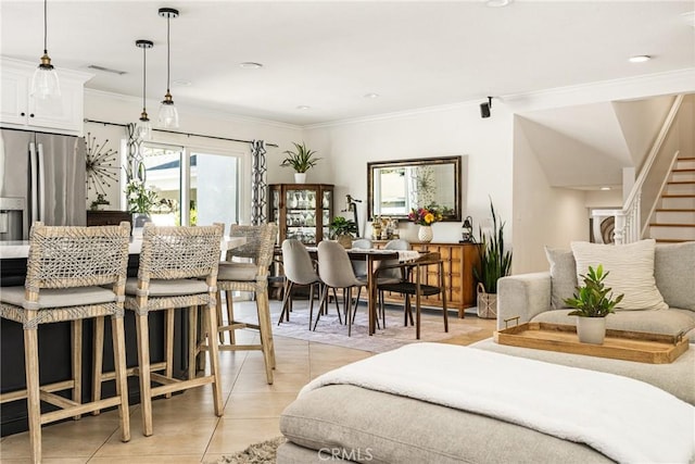 17252 Breda Ln, Huntington Beach, CA 92649 - dining space featuring plenty of natural light, light tile patterned floors, stairs, and crown molding