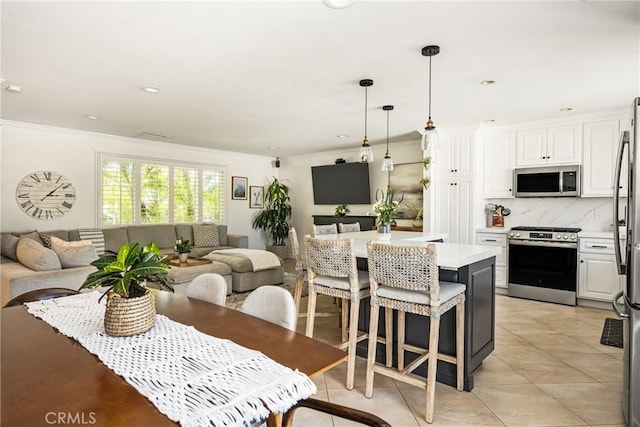 17252 Breda Ln, Huntington Beach, CA 92649 - kitchen with appliances with stainless steel finishes, open floor plan, ornamental molding, light countertops, and white cabinets