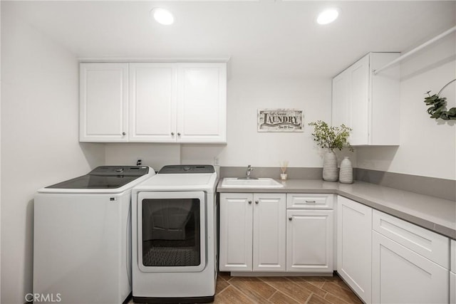 17252 Breda Ln, Huntington Beach, CA 92649 - laundry room with cabinet space, independent washer and dryer, recessed lighting, and wood finished floors
