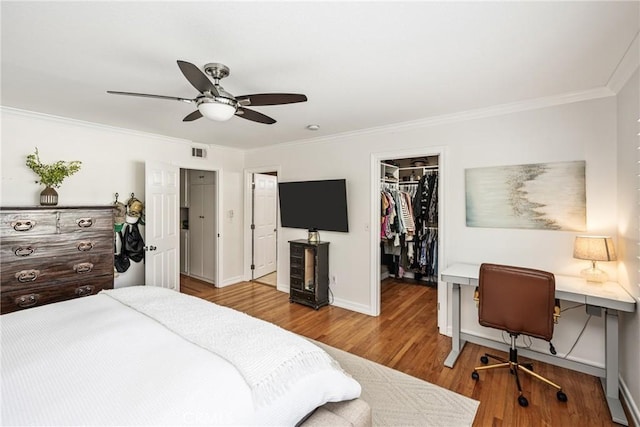 17252 Breda Ln, Huntington Beach, CA 92649 - bedroom with ornamental molding, wood finished floors, an office area, baseboards, and a walk in closet